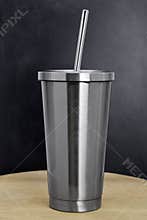Steel mug on wooden backdrops. Blank stainless tumbler for your design. Insulated bottle for keep your drink