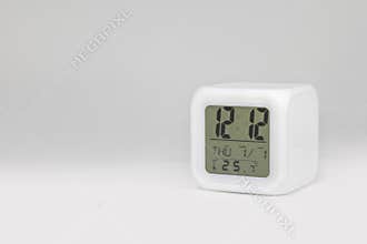 Modern alarm clock on white backdrops and copyspace. LED light or digital display