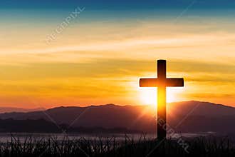 Silhouette of cross on mountain sunrise background