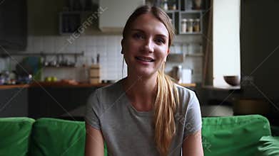 Young woman communicating online making video call talking to camera