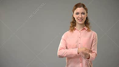 Woman saying good morning in sign language, teacher showing words in asl lesson