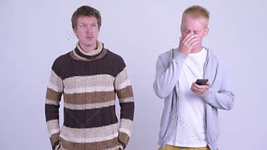 Young man farting with young man looking disgusted