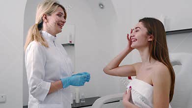 Plastic Surgeon or Cosmetology Specialist Examines Woman`s Face, Touches with Hands, Inspecting Healed Skin after