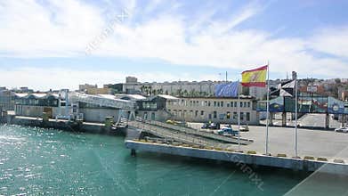 EU, Spanish and regional flags waving in Ceuta port