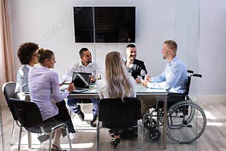 Disabled Manager Sitting With His Colleagues