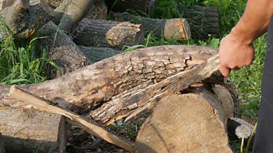 Man woodcutter chopping wood with an old vintage iron ax. Manual cut wood