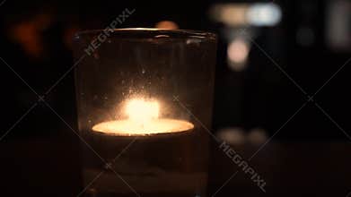 Candle on a table in a bar.