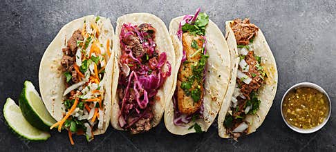 Four mexican street tacos with fish barbacoa and carnitas
