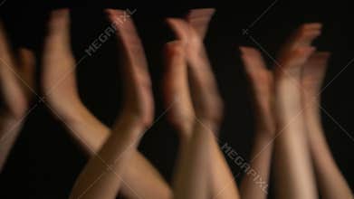 Raising hands with applause or clap on black background.