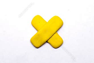 Yellow cross pointer isolated. Modelling clay navigation sign on white background.