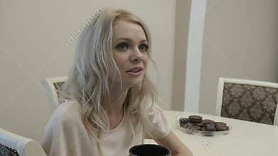 Girl drinks tea and eats coockie