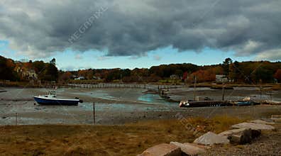 Storm Clouds over boats at low tide