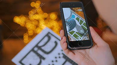 Woman using smartphone with augmented reality app and placing virtual model