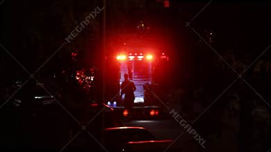 Paramedic Prepares Ambulance for Patient Transport at Night