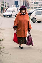 Senior Woman Carrying Shopping Bags
