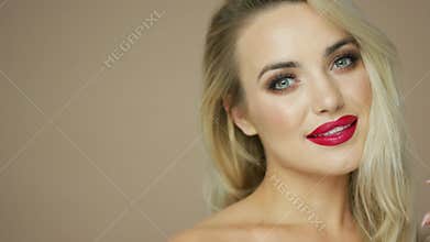 Charming blonde model with red lips