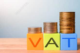 Growing taxes - colour blocks with VAT and money stacks