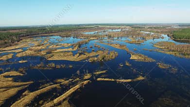 4K. Flight over flooded blue river in early spring, aerial panoramic view