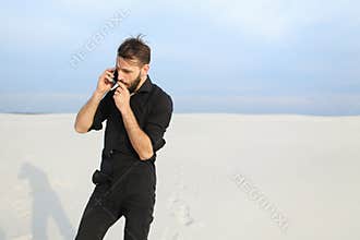 Husband speaking on smartphone with wife walking at seaside sm
