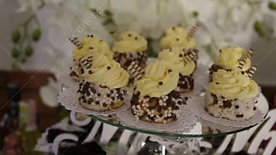 A view from afar on a stunning wedding cake standing on the sweets buffet