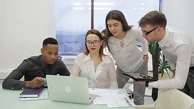 At the office an international team is brainstorming for a laptop.
