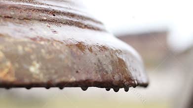 Rain drops on rusty bronze surface of ancient church bell, cultural heritage