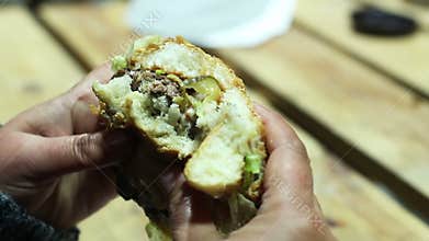 Fast food addict biting disgusting greasy burger, calories and saturated fat