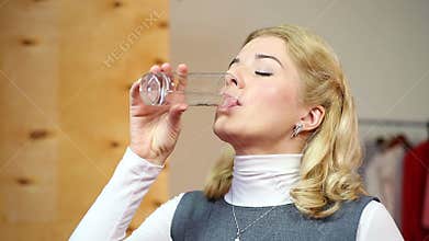 Businesswoman drinking water, thirst. The moisture balance. Healthcare