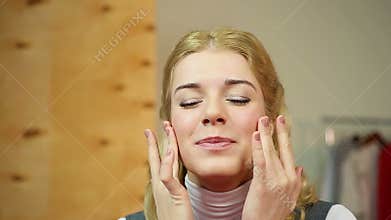 Female applying expensive anti-aging cream, enjoying the smoothing skin effect