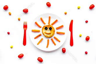 Creative approach to kid`s braekfast. Meal with cheesecake in shape of sun. White background top view