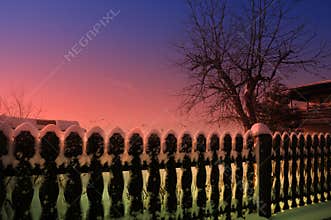 Wintertime, garden and fence of my neighbor covered with snow