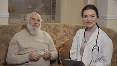 Doctor and old patient shows thumbs up to camera