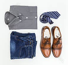 Men`s apparel, shirt, jean, brown shoes and necktie.