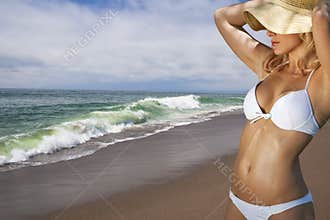 Young blonde woman vacationing at the beach