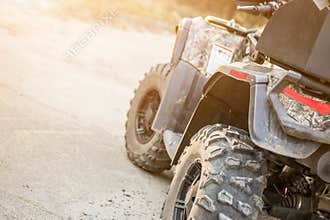 Close-up tail view of ATV quad bike. Dirty whell of AWD all-terrain vehicle. Travel and adventure concept.Copyspace.Toned