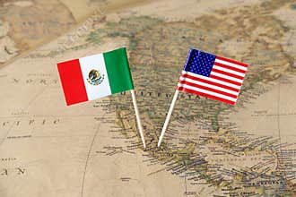 The United States of America and Mexico flag pins on a world map, political relations concept