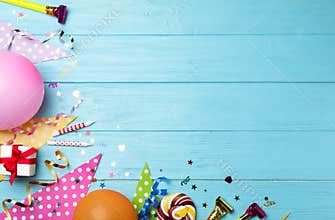 Flat lay composition with birthday party items on blue wooden background