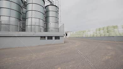 Grain bags and water tanks stay by each other at factory backyard