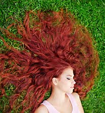 Young girl lying on grass