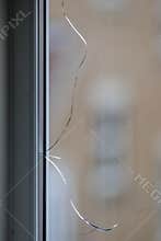 Cracked window. Broken glass pane in double-glazing.