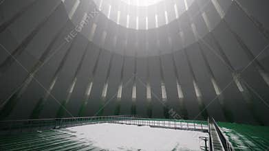 Bridge over green pools in large cooling tower