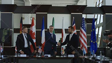 Politicians shaking hands in agreement on negotiation