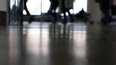 People walking through an airport terminal with suitcases, bags and baggage