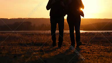 Two friends sunset to go forward, the concept of adventure travel, a backpack on the shoulders