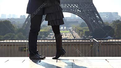 Detail of couple of lovers feet dating close Eiffel tower, man and woman love