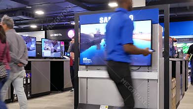 Motion of people looking for a new tv inside electronic store