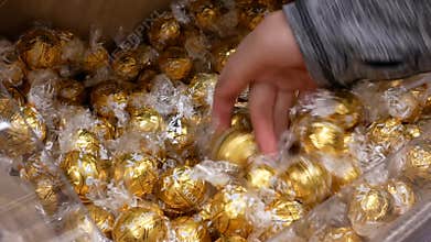 Motion of people buying Lindt bulk white chocolate inside Superstore