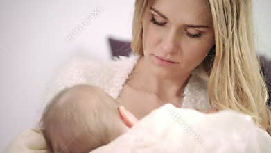 Young mother breast feeding new born child. Enjoy motherhood