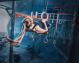 Concept: power, strength, healthy lifestyle, sport. Powerful attractive muscular woman at CrossFit gym