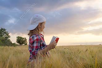 Portrait of the happy beautiful young woman . in the field of wheat